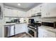 Modern kitchen with stainless steel appliances, white cabinetry, and granite countertops at 3999 Bayside Cir, Doraville, GA 30340