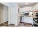 Open kitchen featuring granite counters, stainless appliances, and view into living room at 3999 Bayside Cir, Doraville, GA 30340