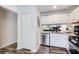 Well-lit kitchen with white cabinets, stainless steel appliances, and a view into the living space at 3999 Bayside Cir, Doraville, GA 30340