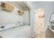 Bright laundry area includes modern appliances, shelving, and a neutral color scheme at 3999 Bayside Cir, Doraville, GA 30340