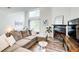 Bright living room with modern fireplace, plush sectional sofa, and sliding glass doors to the outside at 3999 Bayside Cir, Doraville, GA 30340