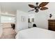 Spacious main bedroom with a ceiling fan, vanity, and desk area, exuding comfort and style at 3999 Bayside Cir, Doraville, GA 30340