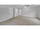 Bright bedroom featuring neutral carpeting and ceiling fan with tray ceiling at 4009 Riverstone Dr, Suwanee, GA 30024