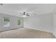 Spacious bedroom featuring neutral carpeting, natural light, and a ceiling fan at 4009 Riverstone Dr, Suwanee, GA 30024