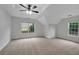 Spacious bedroom features a ceiling fan, light-filled windows, and neutral carpet at 4009 Riverstone Dr, Suwanee, GA 30024