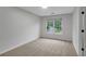 Well-lit bedroom with neutral walls and carpeting with a view of the neighborhood at 4009 Riverstone Dr, Suwanee, GA 30024
