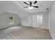 Neutral bedroom features a ceiling fan and two doors to a closet or additional room at 4009 Riverstone Dr, Suwanee, GA 30024