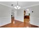 Bright dining room with hardwood floors, crown molding, and elegant chandelier lighting at 4009 Riverstone Dr, Suwanee, GA 30024