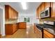 Well-equipped kitchen with granite countertops, stainless steel appliances, and wood cabinetry at 4009 Riverstone Dr, Suwanee, GA 30024