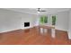 Spacious living room featuring hardwood floors, white brick fireplace, and lots of natural light at 4009 Riverstone Dr, Suwanee, GA 30024