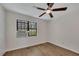 Bedroom with neutral walls, window AC unit, new flooring, and a ceiling fan at 6991 Flagstone Dr, Austell, GA 30168