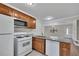 Well-lit kitchen features granite countertops, stainless appliances, and light brown cabinetry at 6991 Flagstone Dr, Austell, GA 30168