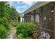 Enjoy the outdoors from the screened in back porch, surrounded by lush landscaping at 219 Cordova St, Woodstock, GA 30189