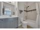 Bathroom featuring modern fixtures, a decorative tile accent, and a shower-tub combination, offering a serene bathing experience at 219 Cordova St, Woodstock, GA 30189