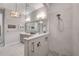 Bathroom featuring a glass shower stall, tile flooring, and decorative pendant lighting at 219 Cordova St, Woodstock, GA 30189