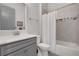A stylish bathroom with a modern vanity, tub-shower combination, and decorative tile accents, offers a spa-like atmosphere at 219 Cordova St, Woodstock, GA 30189