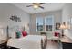 Cozy bedroom with wood floors, ceiling fan, and bright windows at 219 Cordova St, Woodstock, GA 30189