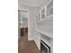 Butler pantry with white cabinetry, countertops, and a wine refrigerator at 219 Cordova St, Woodstock, GA 30189