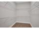 Spacious walk-in closet with shelving units and wood flooring at 219 Cordova St, Woodstock, GA 30189