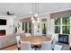 Open-concept dining area featuring a round table, comfortable seating, and views of the outdoors at 219 Cordova St, Woodstock, GA 30189