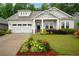 Charming single Gathering home with a lush front yard and a two-car garage at 219 Cordova St, Woodstock, GA 30189