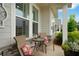 Relax on this home's covered porch with stone accents and comfortable seating at 219 Cordova St, Woodstock, GA 30189