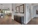 Welcoming hallway with dark wood floors, cabinet, mirrors, and views into the living area at 219 Cordova St, Woodstock, GA 30189
