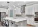 Modern kitchen with stainless steel appliances, a large island with seating, and stylish pendant lighting at 219 Cordova St, Woodstock, GA 30189