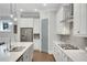 Modern kitchen with stainless steel appliances, white cabinetry, and sleek countertops at 219 Cordova St, Woodstock, GA 30189