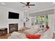 Cozy living room with a fireplace, plush seating, and access to the outdoor patio at 219 Cordova St, Woodstock, GA 30189