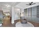 Spacious living room with hardwood floors, built-in shelving, and a comfortable armchair at 219 Cordova St, Woodstock, GA 30189