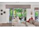 Bright living room with patio access, neutral tones, and comfortable seating arrangement at 219 Cordova St, Woodstock, GA 30189