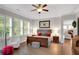 Bright main bedroom featuring hardwood floors, a ceiling fan, and large windows with natural light at 219 Cordova St, Woodstock, GA 30189