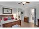 Comfortable bedroom with hardwood floors, neutral decor, and ensuite bathroom access at 219 Cordova St, Woodstock, GA 30189