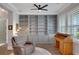 This home office features hardwood floors, built-in shelving, and a charming writing desk at 219 Cordova St, Woodstock, GA 30189