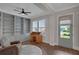 This home office features hardwood floors, built-in shelving, and a charming writing desk at 219 Cordova St, Woodstock, GA 30189