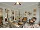A covered patio with stone floors includes stylish seating and decor, accessible through sliding glass doors at 219 Cordova St, Woodstock, GA 30189