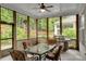 Relaxing screened patio featuring a dining set, grill, and tranquil views, perfect for outdoor entertaining and leisure at 219 Cordova St, Woodstock, GA 30189