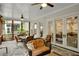 A covered patio provides an inviting outdoor dining and lounging space with stone floors and natural light at 219 Cordova St, Woodstock, GA 30189
