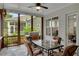 Another view of the relaxing screened patio featuring a dining set, grill, and tranquil views at 219 Cordova St, Woodstock, GA 30189