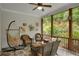 Cozy covered patio with wicker seating, hammock, and views of the yard, creating a relaxing outdoor space at 219 Cordova St, Woodstock, GA 30189