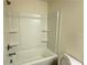 Full bathroom featuring a shower-tub combo with built-in shelves and a standard toilet at 32 S Auburn Landing Pl, Auburn, GA 30011
