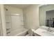 Full bathroom featuring a shower-tub combo with built-in shelves, a modern vanity, and sink at 32 S Auburn Landing Pl, Auburn, GA 30011