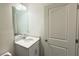 Neutral-toned powder room featuring a single-sink vanity with light countertops and modern hardware at 32 S Auburn Landing Pl, Auburn, GA 30011