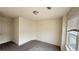 Small bedroom with neutral carpet and a large window bringing in plenty of light at 32 S Auburn Landing Pl, Auburn, GA 30011