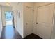 Bright, modern townhouse entry with dark wood floors and white doors at 32 S Auburn Landing Pl, Auburn, GA 30011