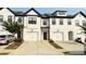 Charming townhome with white brick, black trim, garage, and modern design at 32 S Auburn Landing Pl, Auburn, GA 30011