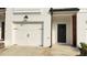 Inviting townhouse facade with a white garage door and modern design at 32 S Auburn Landing Pl, Auburn, GA 30011