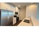 Modern kitchen with white cabinets, stainless steel appliances, and quartz countertops at 32 S Auburn Landing Pl, Auburn, GA 30011