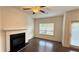 Cozy living room featuring fireplace, ceiling fan and a window for natural light at 32 S Auburn Landing Pl, Auburn, GA 30011